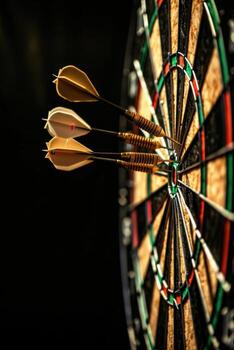 Three darts hitting the bullseye of a dartboard photo