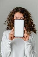 Woman holding white blank smartphone screen in front of her photo