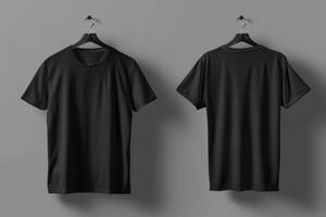 Two black mockup t-shirts hanging on hangers against a gray wall. photo