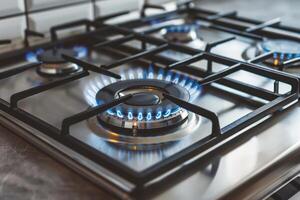 Close up of a lit gas stove burner in a modern kitchen photo