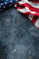 American flag draped on dark blue textured vertical surface, copy space photo