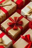 Close up of gold and red wrapped gift boxes on a red surface. photo