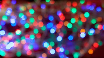 Multicolored abstract holidays lights in bokeh, on a dark background photo