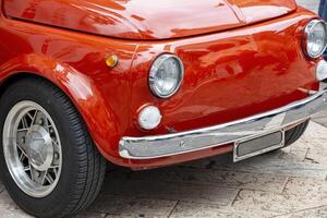 Vintage Red Classic Car Close-Up with Chrome Details and Retro Design photo