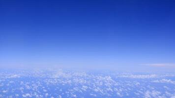 Horizontal gradient blue sky with white fluffy clouds photo