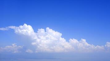 Horizontal gradient blue sky with white fluffy clouds photo