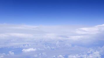 Horizontal gradient blue sky with white fluffy clouds photo