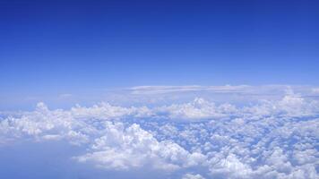 Horizontal gradient blue sky with white fluffy clouds photo