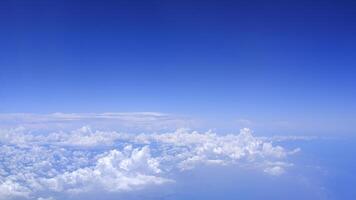 Horizontal gradient blue sky with white fluffy clouds photo