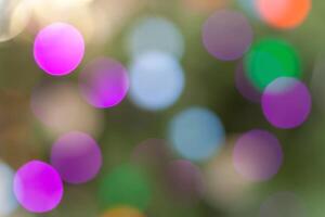 Multicolored abstract holidays lights in bokeh, on a dark background photo