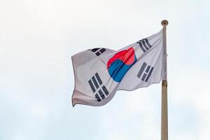 View on a flag of South Korea on a background of grey cloudy sky photo