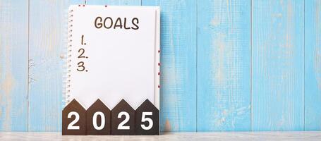 2025 Happy New Year with GOAL word and wooden number. time for a New Start, Resolution, Plan, Action and Mission Concept photo