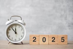 Happy New Year with vintage alarm clock and 2025 block. Christmas, New Start, Resolution, countdown, Goals, Plan, Action and Motivation Concept photo