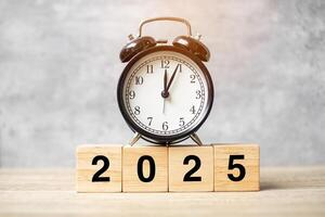 2025 text with clock on table. Resolution, time, plan, goal, motivation, reboot, countdown and New Year holiday concepts photo