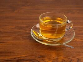 Teacup on a wooden table. Space for text. Morning beverage and relaxation concept photo