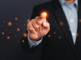 Businessman pressing a button on virtual screen. Man pointing on a futuristic interface. Space for text. Futuristic business and Innovation technology internet business concept photo