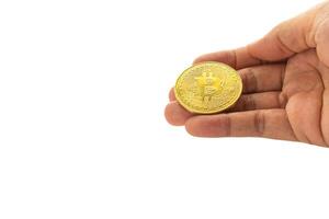 Bitcoin golden coin on the palm with a white background. Close-up photo. Space for text. Virtual cryptocurrency and future money concept photo
