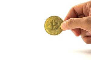 Close-up of hand holding a bitcoin golden coin with a white background. Close-up photo. Space for text. Virtual cryptocurrency and future money concept photo