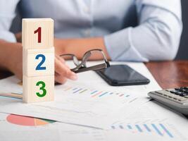 Close-up of wooden dice with numbers 1,2,3 are placed on a table in the office. Space for text. Step by step concept photo
