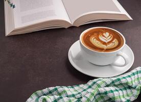 Top view of a book with a white coffee cup, and a cloth placed on a dark brown background. Space for text. Concept of relaxation photo