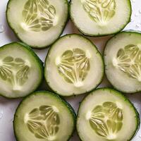 Fresh a pile of Fresh organic cucumber against a white background photo
