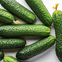 Fresh a pile of Fresh organic cucumber against a white background photo