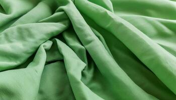 Texture of crumpled fine green cotton fabric as background. Shabby bed sheets. top view.pattern texture background photo