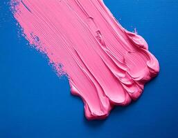 Abstract pink oil paint texture on blue canvas or wall. Minimalistic background with copy space. photo