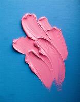 Abstract pink oil paint texture on blue canvas or wall. Minimalistic background with copy space. photo