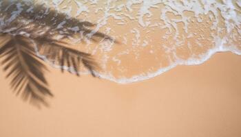 empty abstract sand beach with palm leaf shadow and transparent water wave from above, blank background banner for travel, vacation and wellbeing with copy space. top of views, aerial views. photo