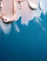 Abstract pink oil paint texture on blue canvas or wall. Minimalistic background with copy space. photo