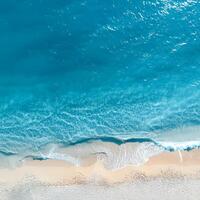 empty abstract sand beach with palm leaf shadow and transparent water wave from above, blank background banner for travel, vacation and wellbeing with copy space. top of views, aerial views. photo