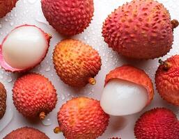 Creative food concept. Fresh a pile of Top view of half ripe Fresh ripe Red Lychee fruit isolated on white background. photo
