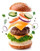 Delicious burger with many ingredients isolated on white background Tasty cheeseburger splash sauce photo
