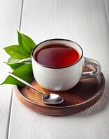 Glass cup of hot aromatic tea with leaves on clear white background photo