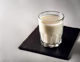 Glass of milk on white background photo