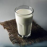 Glass of milk on white background photo