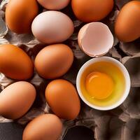 photo pallet with eggs and raw broken egg with yolk. Pattern texture background