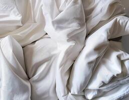 Background concept. Soft bed sheets that are still wrinkled after being used. The white bed sheets were crumpled and shabby. Pattern texture background. photo