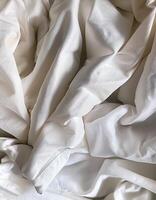 Background concept. Soft bed sheets that are still wrinkled after being used. The white bed sheets were crumpled and shabby. Pattern texture background. photo