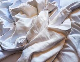 Background concept. Soft bed sheets that are still wrinkled after being used. The white bed sheets were crumpled and shabby. Pattern texture background. photo
