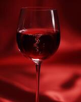 Glass of Red Wine on Red Cloth photo