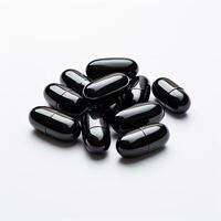 Stack of Black Pills on White Table photo
