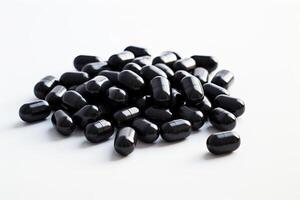 Stack of Black Pills on White Table photo