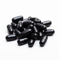 Stack of Black Pills on White Surface photo