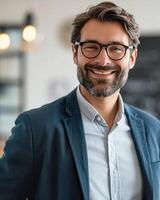 Smiling Man With Glasses in Front of Chalkboard photo