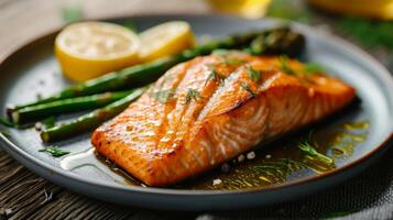 Plate of Salmon and Asparagus on Table photo