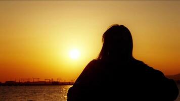 Young Woman Silhouette in Sunset photo
