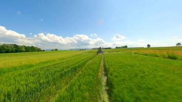 Smooth FPV flight behind a tractor spraying an agricultural field. video