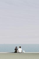 Couple of lover with cat sitting on barrier at seaside in a foggy day graphic illustration. Travel with pet landscape minimalism concept vertical shape have blank space. vector